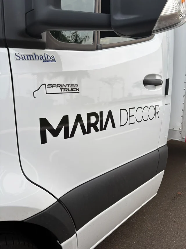 Detalhe da marca Maria Decor aplicada na porta do veículo